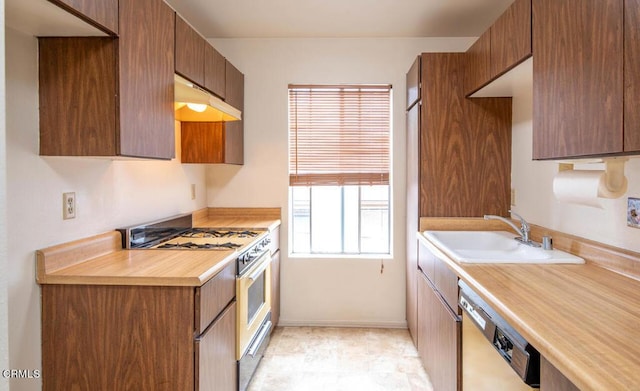 kitchen with stainless steel dishwasher, sink, and gas range gas stove