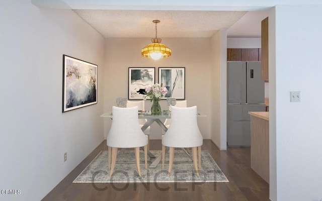 dining room featuring dark wood-type flooring and a textured ceiling