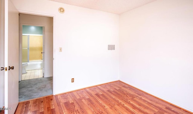 spare room with hardwood / wood-style floors