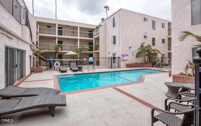 view of swimming pool with a patio area