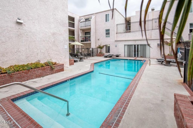 view of swimming pool with a patio area