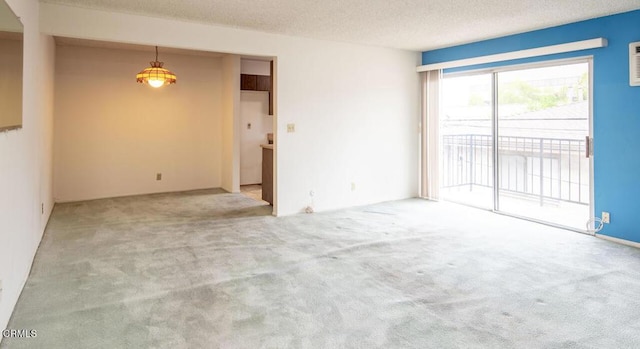 unfurnished room featuring carpet flooring and a textured ceiling