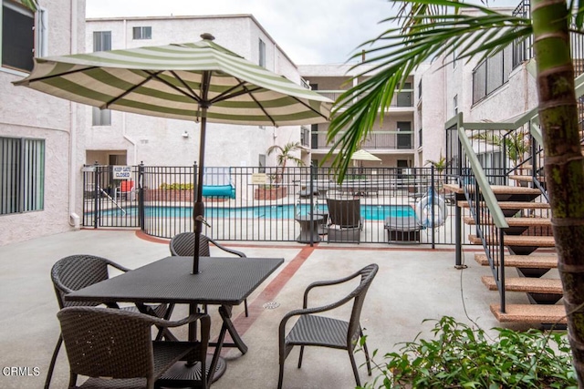 view of patio / terrace featuring a community pool