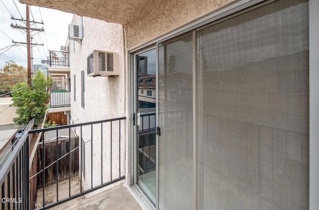 balcony featuring an AC wall unit