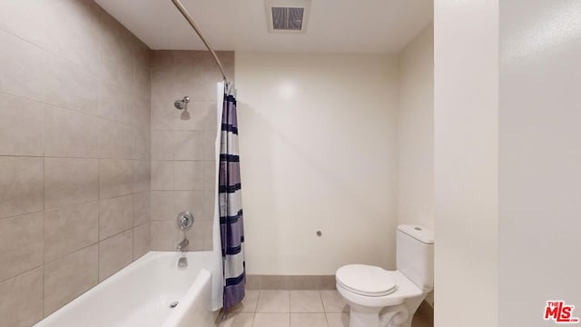 bathroom with tile patterned floors, shower / bath combination with curtain, and toilet