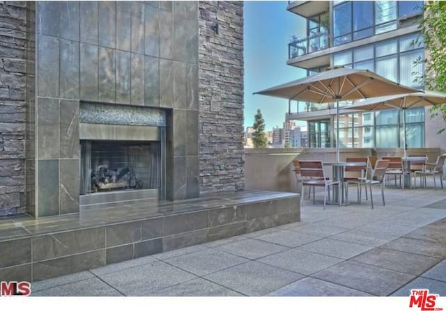 view of patio featuring a fireplace