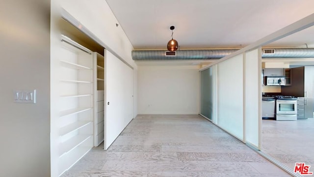 hall with light wood-type flooring