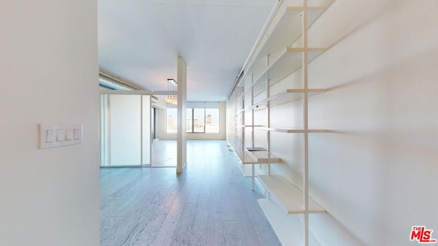 corridor with wood-type flooring