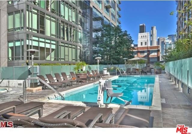 view of swimming pool featuring a patio area