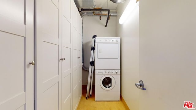 laundry area with stacked washer and clothes dryer