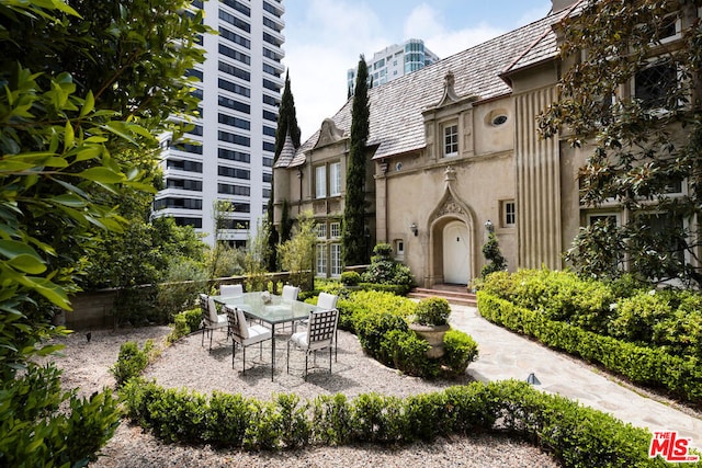 view of home's community with a patio area