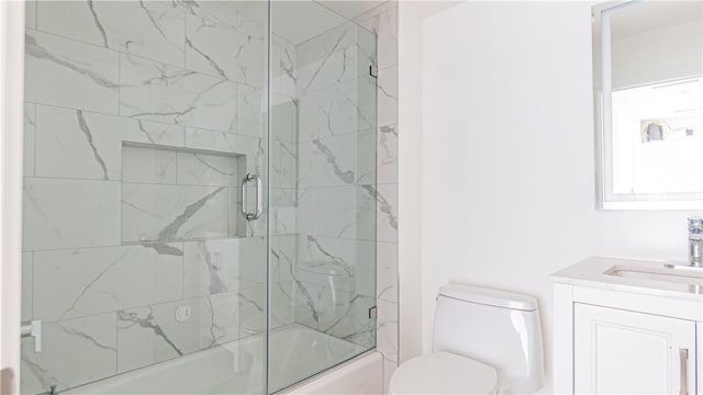 full bathroom featuring vanity, toilet, and combined bath / shower with glass door