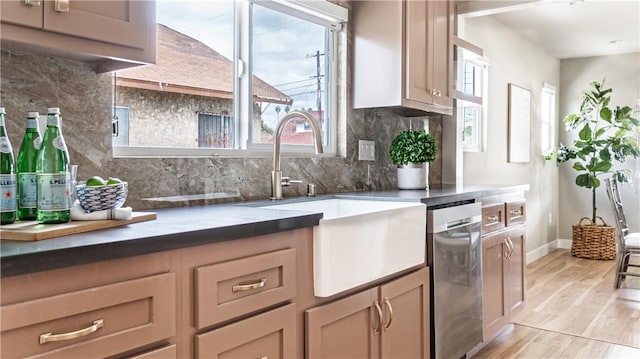 kitchen with decorative backsplash, light hardwood / wood-style floors, sink, and a wealth of natural light