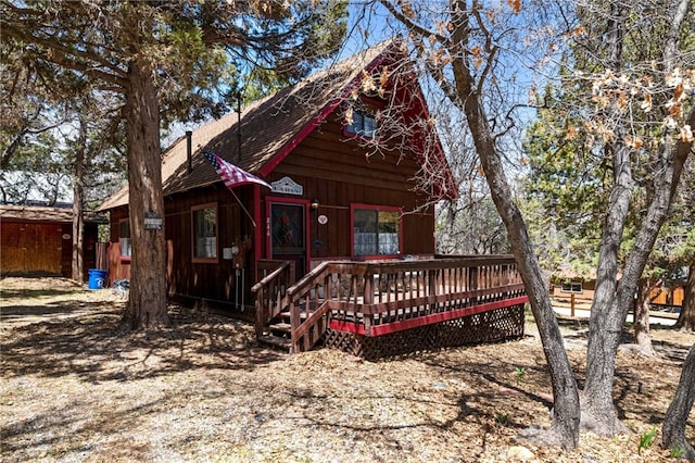 rear view of house with a wooden deck