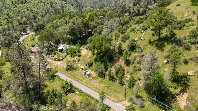 drone / aerial view featuring a wooded view