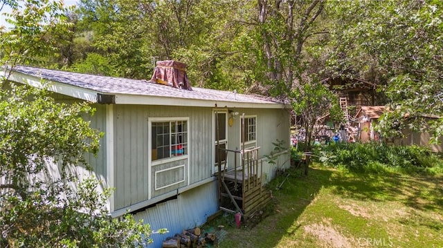 exterior space featuring a yard and a chimney