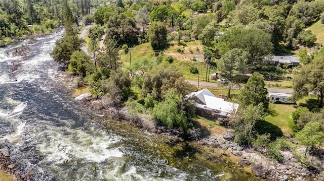 birds eye view of property featuring a view of trees