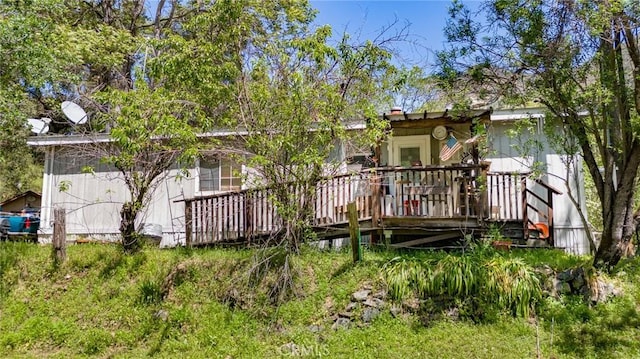 back of property featuring a deck