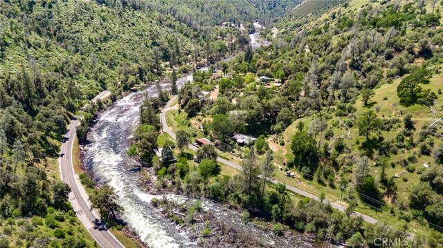 birds eye view of property featuring a view of trees