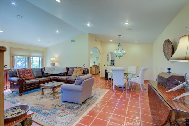 living room featuring lofted ceiling, an inviting chandelier, and tile patterned flooring