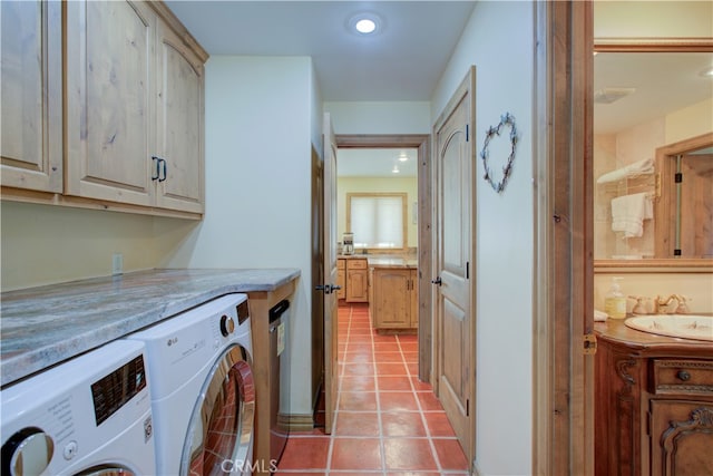 washroom featuring sink, independent washer and dryer, light tile patterned floors, and cabinets