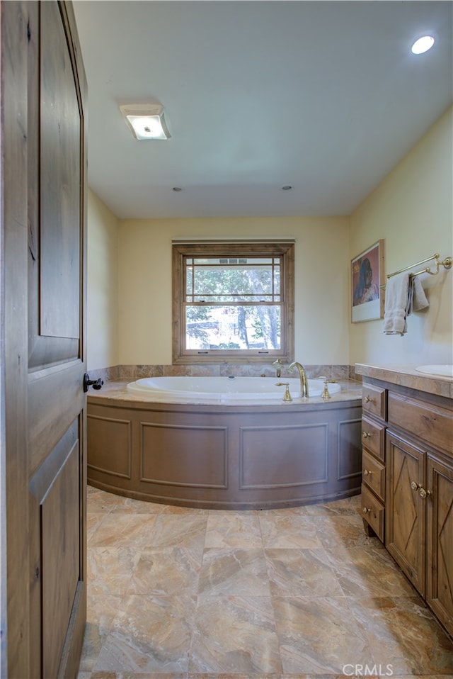 bathroom featuring vanity and a tub to relax in