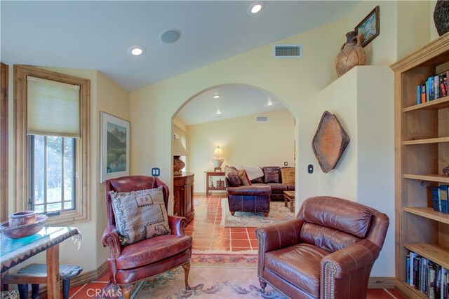 living area featuring light tile patterned floors and lofted ceiling