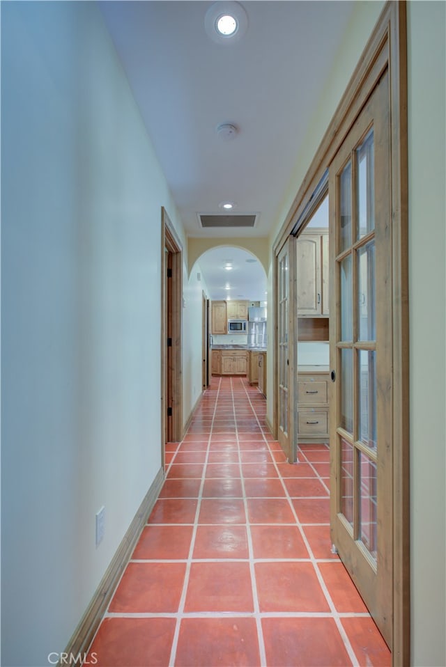 hallway featuring tile patterned flooring