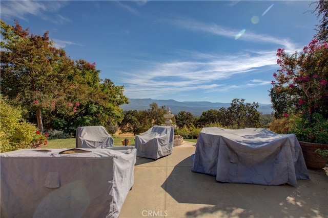 view of patio with a mountain view and grilling area