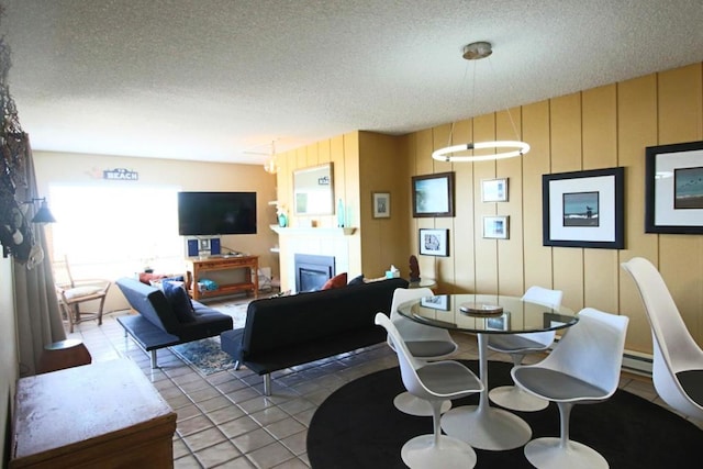 living room featuring tile patterned floors, a textured ceiling, and a baseboard heating unit