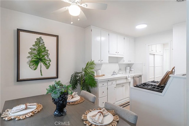 kitchen featuring white cabinets, appliances with stainless steel finishes, ceiling fan, and sink