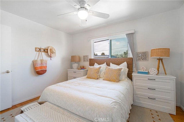 bedroom with ceiling fan and light wood-type flooring