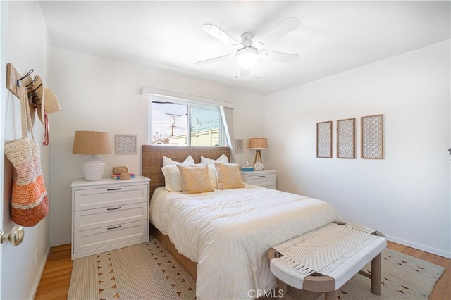 bedroom with light wood-type flooring and ceiling fan