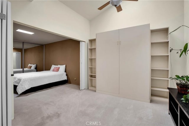 bedroom featuring vaulted ceiling, light colored carpet, and ceiling fan