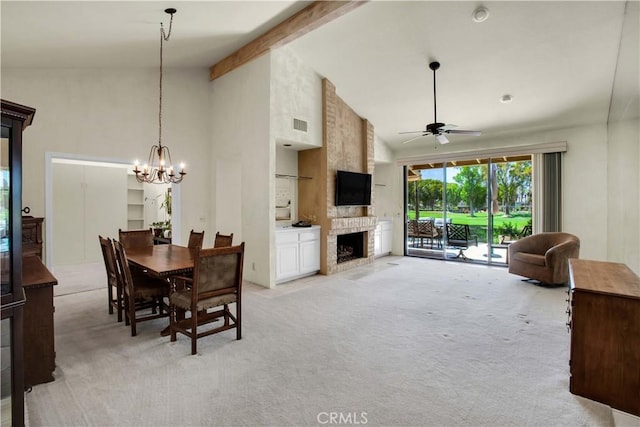 carpeted dining area featuring high vaulted ceiling, a large fireplace, ceiling fan with notable chandelier, and beam ceiling