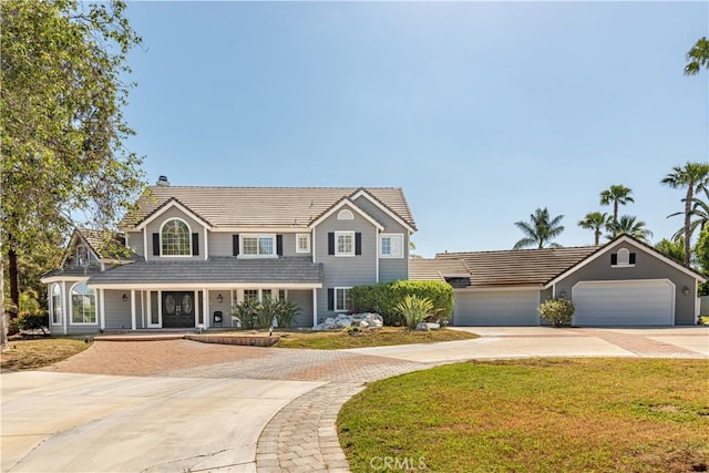 view of front of house with a garage and a front yard