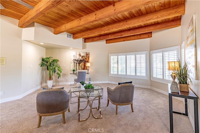 carpeted living room with beam ceiling and wooden ceiling