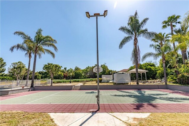 view of tennis court with a gazebo and basketball court