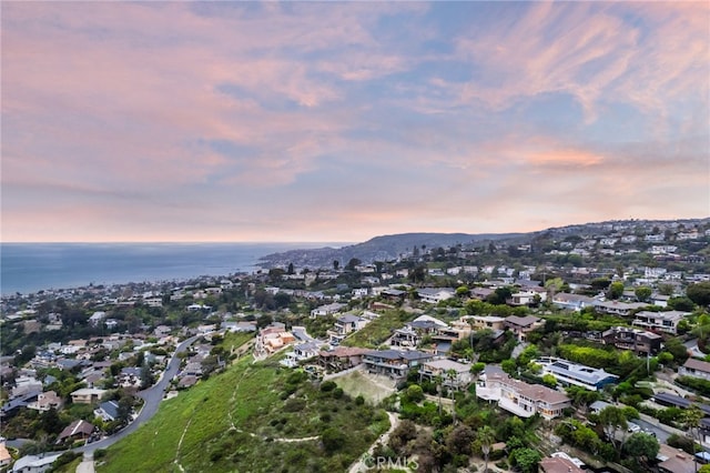 aerial view at dusk with a water view