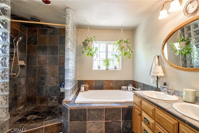 bathroom featuring vanity and shower with separate bathtub