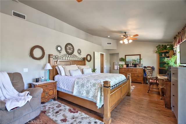 bedroom with hardwood / wood-style floors, ceiling fan, and vaulted ceiling