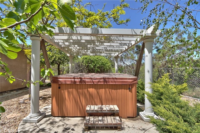 view of patio / terrace with a pergola and a hot tub