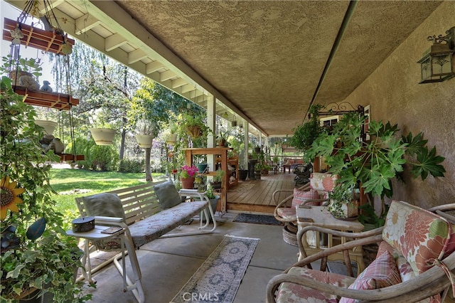 view of patio featuring covered porch and a deck