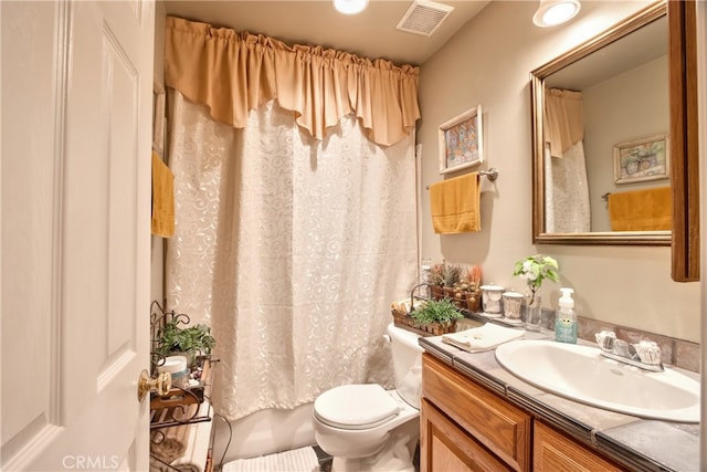 full bathroom with vanity, shower / bath combination with curtain, and toilet