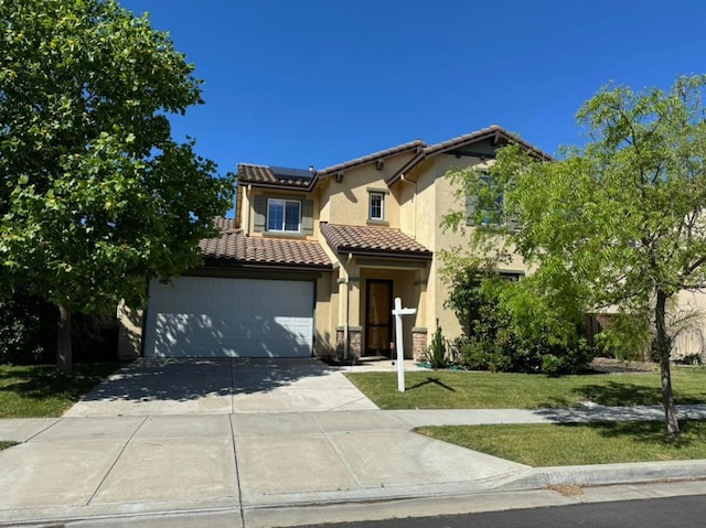 mediterranean / spanish-style house with a front lawn, a garage, and solar panels