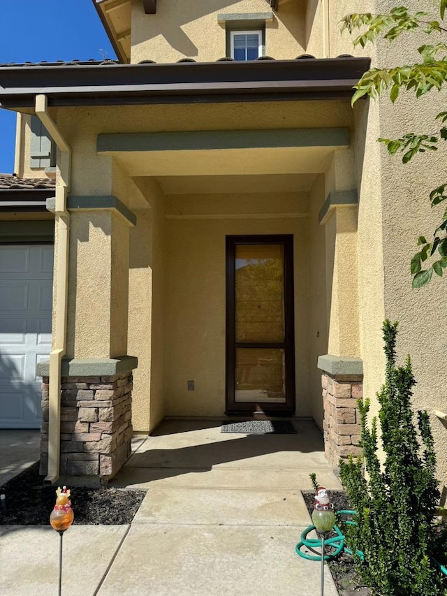 doorway to property featuring a garage