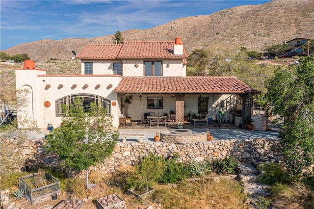 rear view of property with a patio and a mountain view