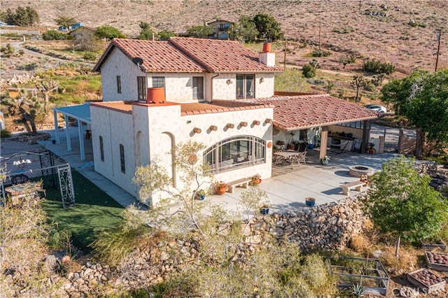 rear view of property featuring a patio