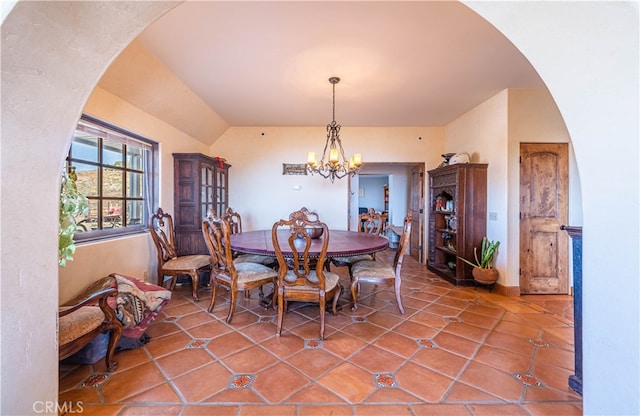 tiled dining area featuring a notable chandelier