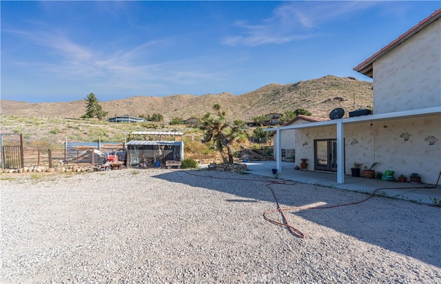 view of yard with a mountain view and a patio